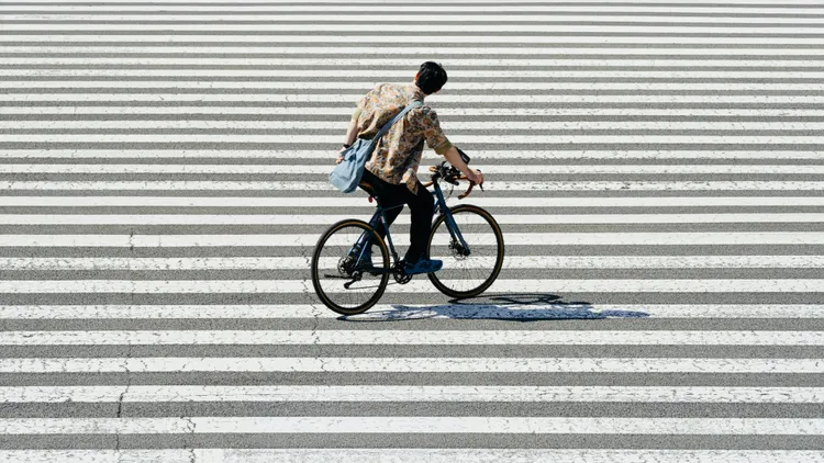 Urban Cyclist Crossing the Street